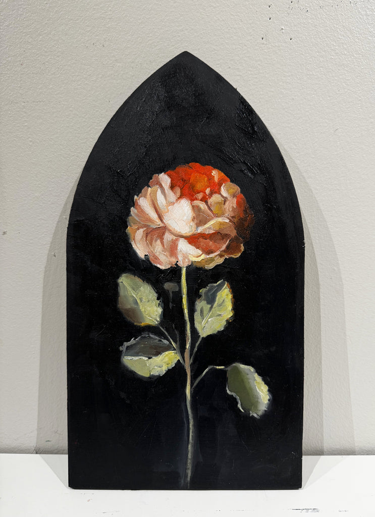 Painting of a flower against a black background on a shaped wooden panel.