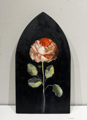 Painting of a flower against a black background on a shaped wooden panel.