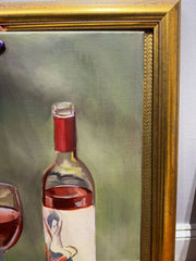 Framed painting of a wine bottle and glass with a gold frame.