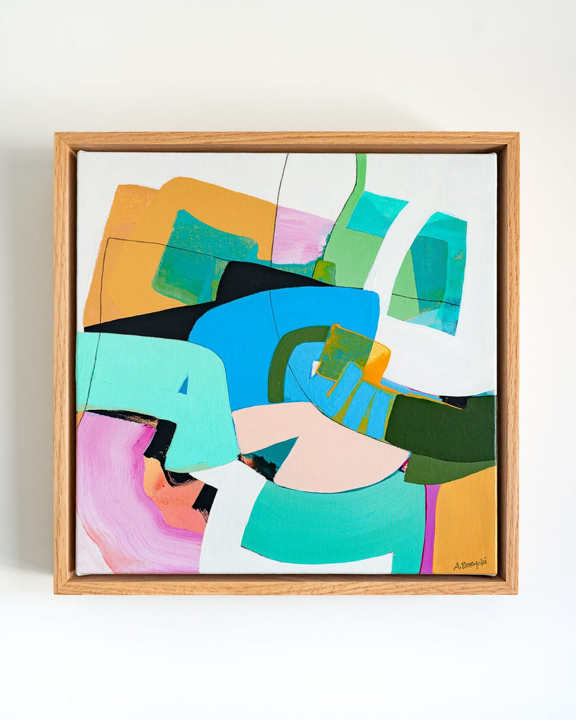 Framed abstract artwork with colorful geometric shapes on a white background
