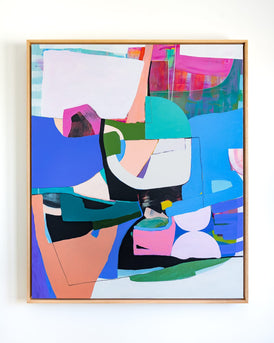 Abstract colorful artwork in a wooden frame on a white wall