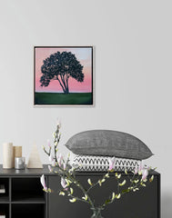 Framed artwork of a tree on a wall above a black console table with decorative items.