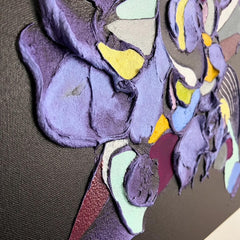Abstract art piece with multicolored shapes on a brown background