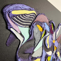 Colorful abstract art piece on a dark surface