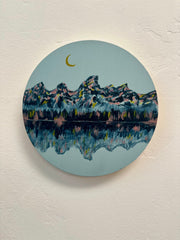 Circular artwork original fine art painting of mountains and a moon on a light blue background