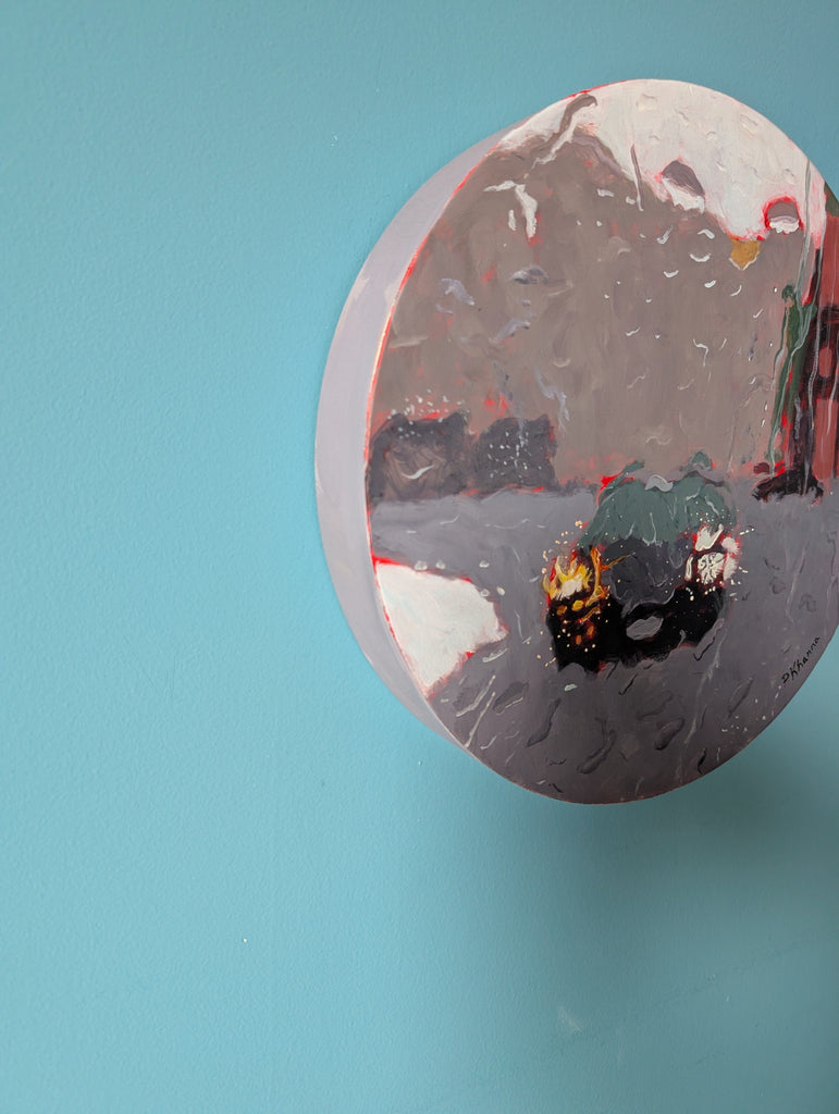 Round painting with abstract design on a blue background