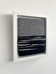 Framed denim art sustainable upcycled on a white wall