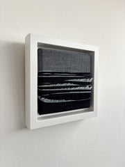 White frame denim ocean art on a white wall