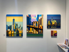 Four abstract cityscape paintings on a wall