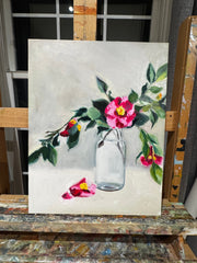 Painting of flowers and a glass jar on an easel.