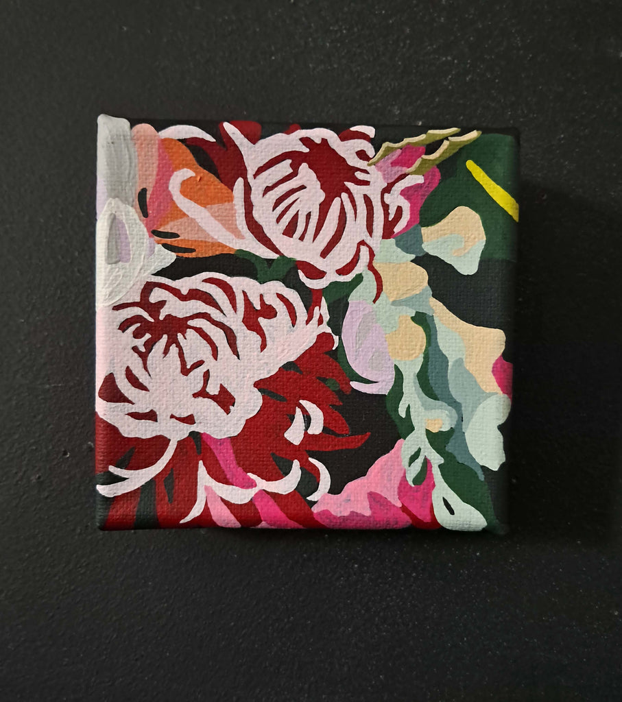 Square painting on canvas with colorful floral design on a black background