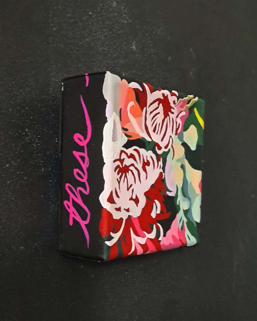 Small rectangular original painting on canvas with floral design and 'these' text on a black background
