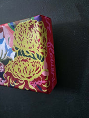 Decorative canvas painting with floral patterns on a dark surface