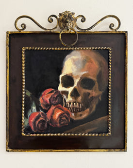 Framed artwork of a skull and roses on a white background