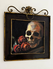 Framed artwork of a skull and red roses on a white background