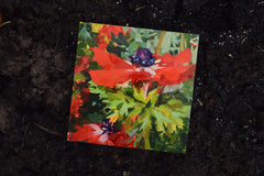 Colorful floral painting on a dark textured surface