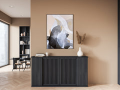 Modern interior with a black console table, abstract painting, and decorative items.