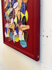 Colorful abstract art piece on a red background