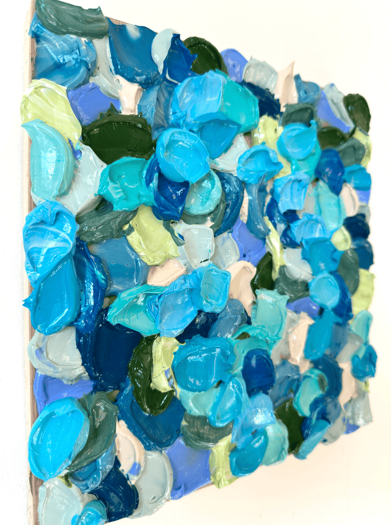 Colorful acrylic painting hung on a white wall