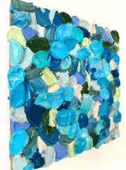 Colorful acrylic painting hung on a white wall