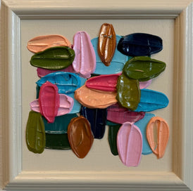 Colorful abstract art piece in a painted beige frame