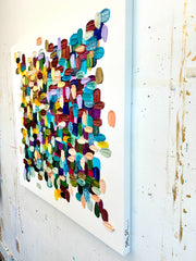 Colorful abstract wall art made from small, multicolored layered brushstrokes on a white background.