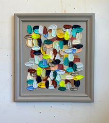 Framed abstract artwork with colorful textured brushstrokes on a white wall by artist Shiri Phillips