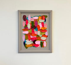 Framed abstract art piece with colorful shapes on a white wall Shiri Phillips