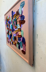 Colorful abstract art piece on a white wall