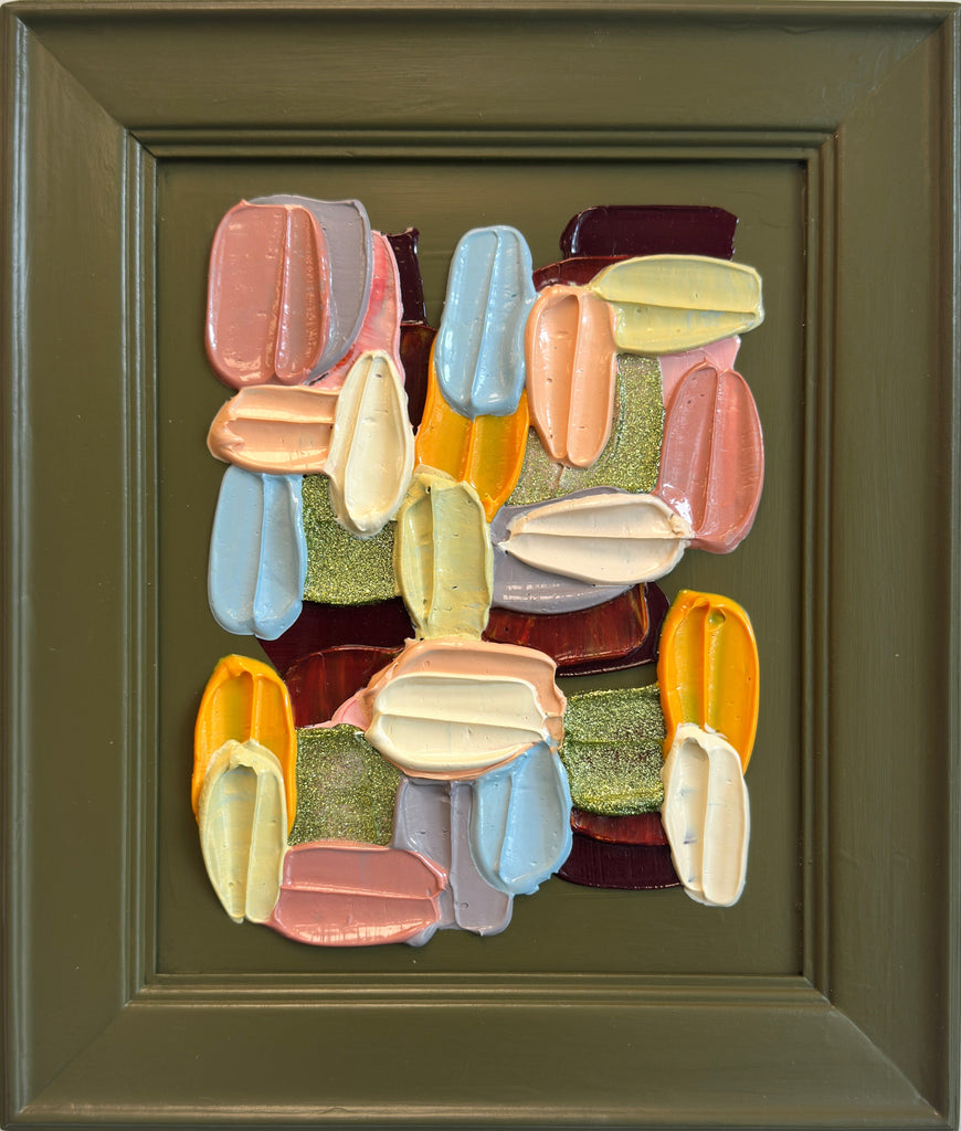 Colorful abstract wall art piece on a green background