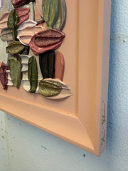 Artistic brushstrokes in various colors on a textured surface with a peach-colored frame.