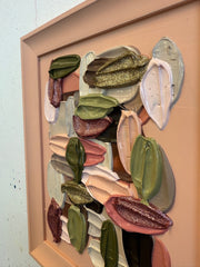 Framed artwork with colorful abstract shapes on a textured wall.