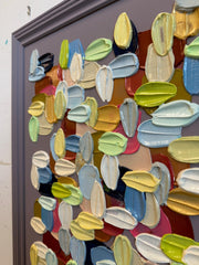 Colorful abstract art piece with various shapes and colors on a textured surface.