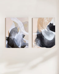 Two abstract art paintings on a wall with a neutral background