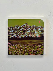 Painting of a mountain landscape with a lake on a textured white wall by Jennifer Peart