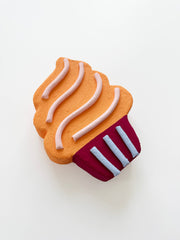 pop art cupcake wall sculpture with orange top and red bottom on a white background
