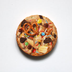 Cookie oil painting with pretzel, chocolate chips, and colorful sprinkles on a white background