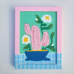 Framed artwork of a cactus with flowers on a teal background