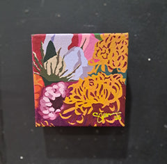 Square painting with colorful floral and abstract patterns on a black background